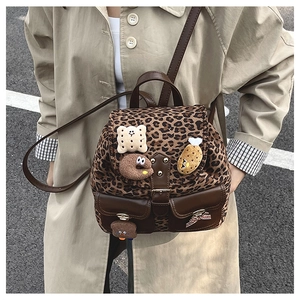 Leopard print kids backpack with plush food charms and brown leather pockets