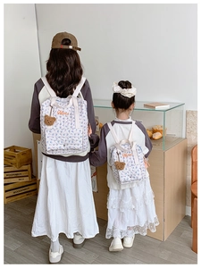 Matching floral quilted backpacks in parent and child sizes with Merci embroidery
