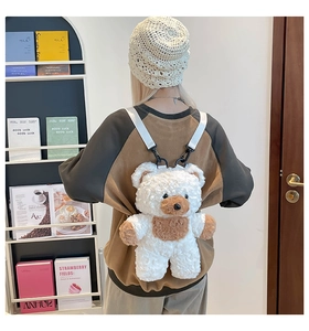 Detail of white teddy bear plush backpack showing soft fleece texture and adjustable straps