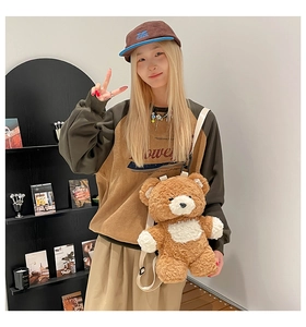 Detail view of cute teddy bear plush backpack with soft fleece texture and nylon strap