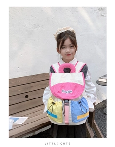 Detail of colorful kids backpack featuring drawstring pockets and fashion embroidery