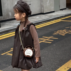 Toddler girl in brown dress and beret with cute rabbit chain crossbody round bag