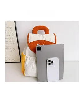 Size comparison of a colorful canvas kids backpack with a tablet and smartphone