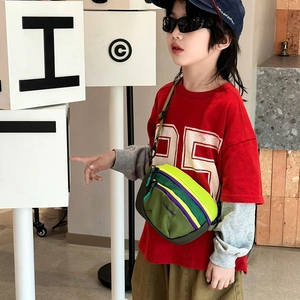 Kids colorful patchwork crossbody bag with adjustable strap worn by a young model