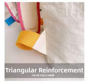 Close-up of triangular reinforcement stitching on fashionable kids colorblock backpack
