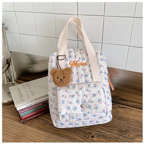 Quilted floral kids backpack with orange Merci embroidery and a cute teddy bear charm