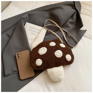 Détail du sac champignon en peluche montrant la texture douce en peau de mouton et pois blancs