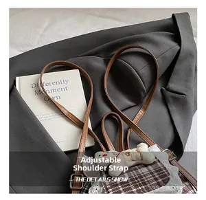 Detail showing the adjustable long leather shoulder strap on the cute lace plaid backpack