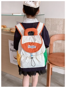 Detail of color-block kids backpack with drawstring closure and Fashion patch embroidery