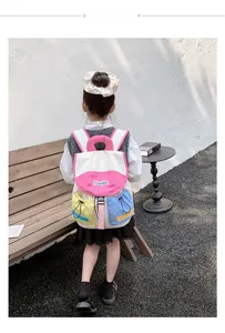 Outdoor shot of a child wearing a colorful color-block nylon backpack with drawstring details