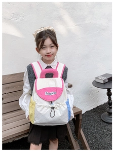 Detail of a lightweight kids' backpack featuring color-block design and drawstring closure