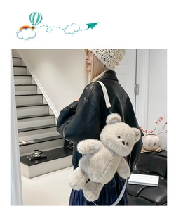 Close-up of cute plush bear backpack for kids with soft beige faux fur and adjustable straps