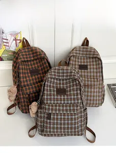 Three plaid kids backpacks in brown, grey and green with cute plush bear charms