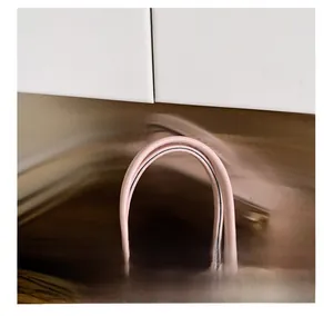 Detailed macro view of pink handbag handles and leather texture with clasp closure