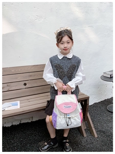 Detail of color-block kids backpack with Fashion embroidery and drawstring closure