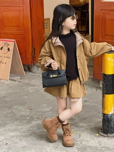 Detail of a khaki girls' utility jacket with plaid collar and matching mini skirt