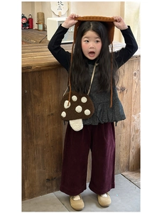 Détail du sac champignon en peluche porté avec une tenue d'automne en tricot pour enfant