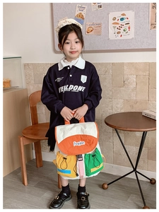 Detailed view of color-block nylon kid backpack with drawstring pockets and flap closure