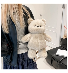 Detail of cute beige plush bear backpack with soft faux fur and adjustable straps
