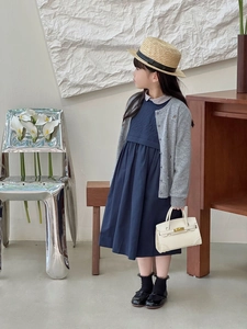 Detail of a white mini handbag with metallic clasp for girls in a modern interior setting
