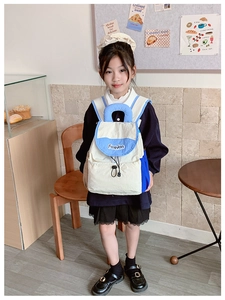 Detail view of a lightweight blue and cream color-block kids backpack with drawstring closure