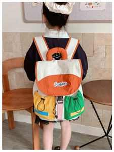 Detailed back view of kids color-block backpack with drawstring pockets and fashion patch