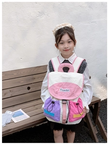 Detail of color-block kids backpack with Fashion text, drawstring and pink handle