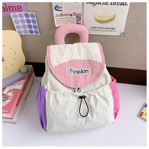 Detail of multi-color drawstring backpack with cream and pink panels and Fashion embroidery
