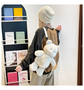 Detail view of a plush cream bear backpack for kids with soft faux fur and fabric straps