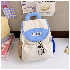 Detail of color-block nylon backpack featuring drawstring closure and Fashion embroidery