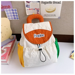 Detail of color-block nylon backpack with adjustable drawstring and fashion patch