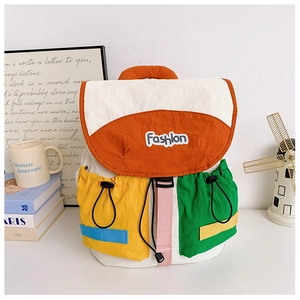 Detail of color-block kids backpack with orange flap and drawstring side pockets