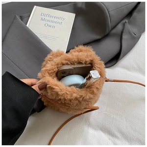 Internal view showing storage capacity for phone and cosmetics in the brown plush bag
