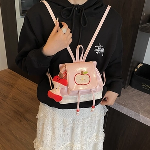 Pink cartoon apple backpack for kids with polka dot canvas and plush charm accessory