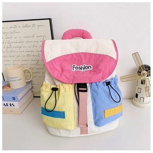 Detail of trendy contrast-color backpack featuring multi-pocket design and buckle closure