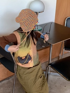 Close-up of children's vintage mini chain crossbody bag with knit sweater outfit
