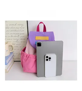 Size comparison of the colorful school backpack next to a tablet and smartphone