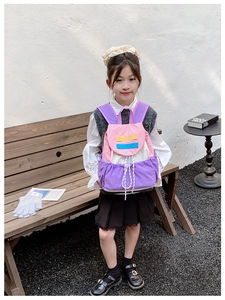 Detail of color-block kids backpack with nylon fabric and drawstring pocket for school