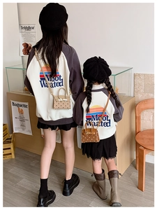 Detailed view of a trendy polka dot mini handbag for kids styled with a casual outfit