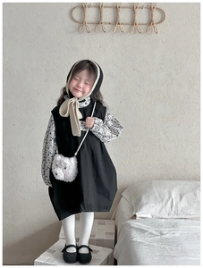 Detail of a cute white plush bear crossbody bag styled with a minimalist kids outfit