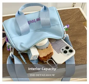 Detail view of the interior capacity of the blue bucket bag with Purple lettering