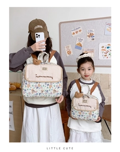 Matching set of floral bear backpacks in two sizes for parents and kids with cute plush charms