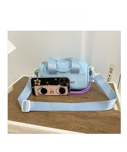 Detailed size comparison of a light blue kids bucket bag with purple letter print