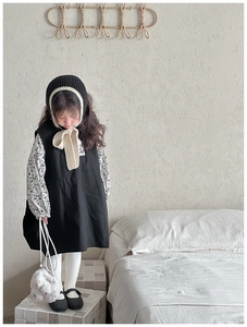 Detail of cute plush bear crossbody bag styled with autumn children's outfit and scarf