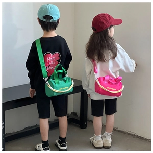 Detail of neon green and pink nylon bucket bags with letter prints and yellow handles