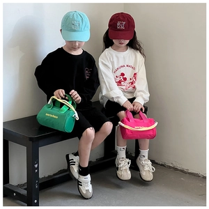 Lifestyle shot of kids wearing canvas bucket bags and casual streetwear outfits