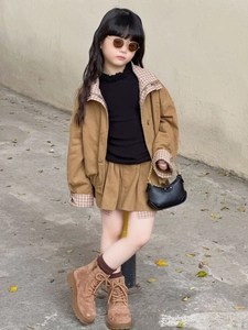 Detail of girls' brown utility jacket with plaid lining and stylish matching skirt set