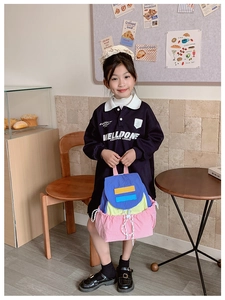 Detail of color-block kids backpack with drawstring closure in blue yellow and pink