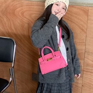 Mini rose red crossbody bag for children with golden twist lock and adjustable strap