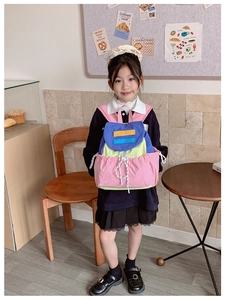 Detailed view of kids color-block backpack with drawstring pocket and large capacity